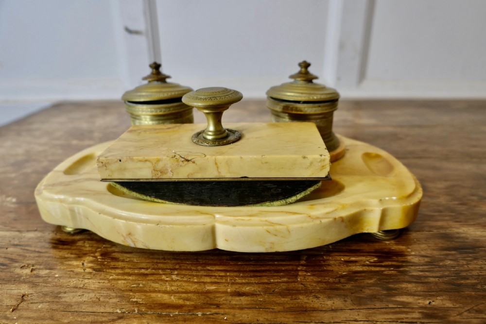 A French veined marble inkstand featuring two turned brass inkpots and a matching rectangular marble rocker blotter set on a shaped base. View II