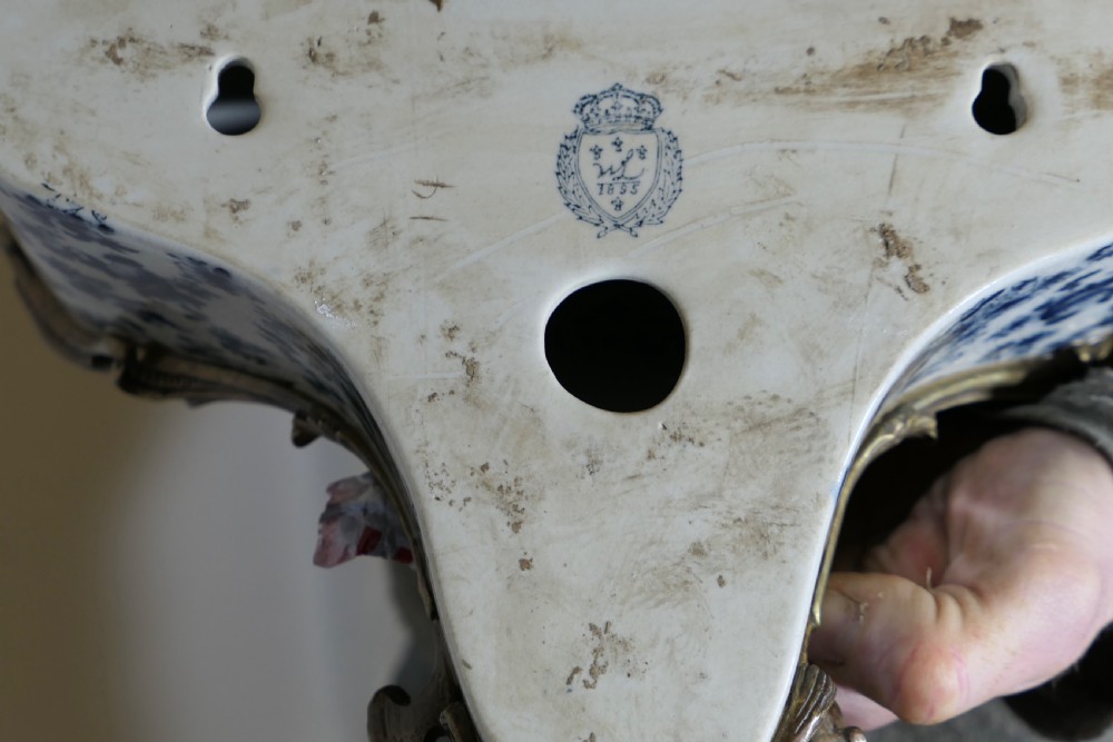 A Rococo revival wall bracket featuring blue and white floral glazed ceramic enclosed in ornamental gilt bronze foliage scrollwork. View VII