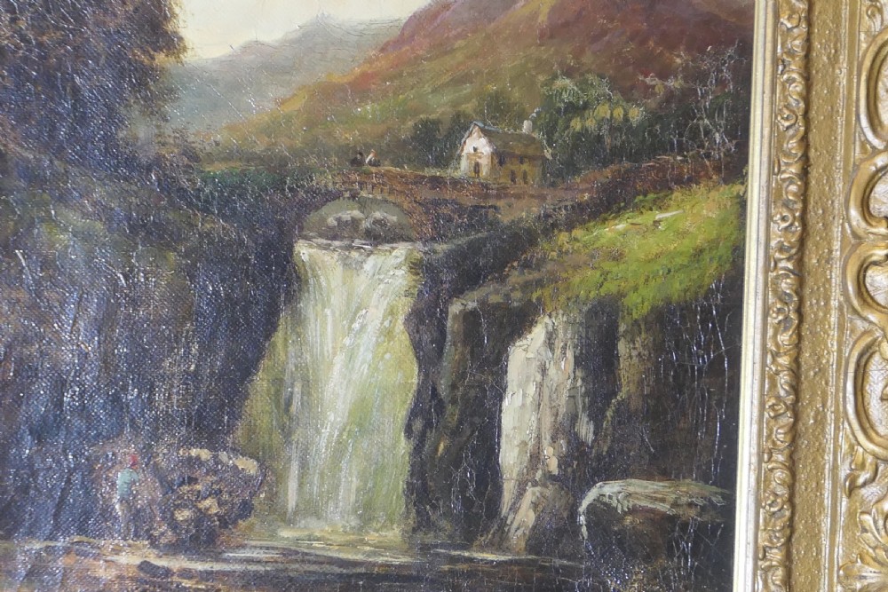 An antique Victorian oil painting depicting a cascading waterfall in a mountainous landscape, framed within an ornate gilded frame. View V