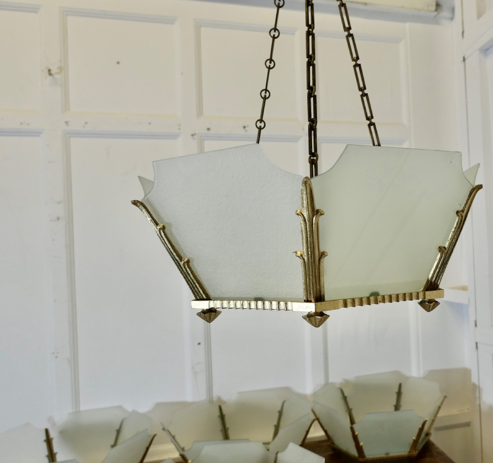 A set of six Art Deco Odeon-style pendant light shades featuring angular frosted glass panels set within brass frames. View III