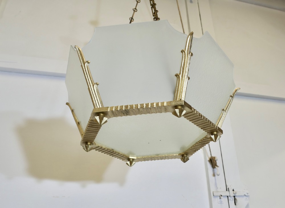 A set of six Art Deco Odeon-style pendant light shades featuring angular frosted glass panels set within brass frames. View IV