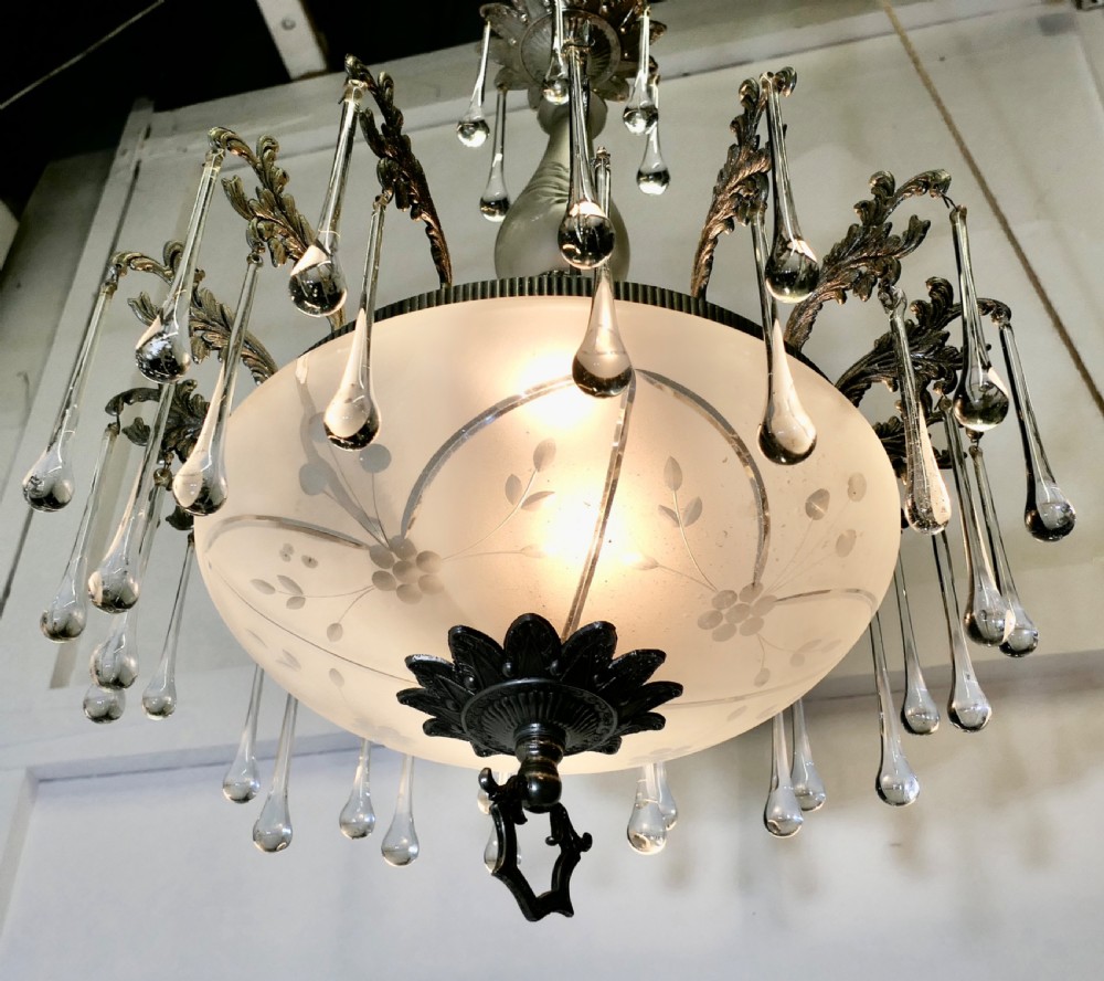 A brass and frosted glass bowl chandelier featuring scrollwork detailing and hanging teardrop crystal drops. View II