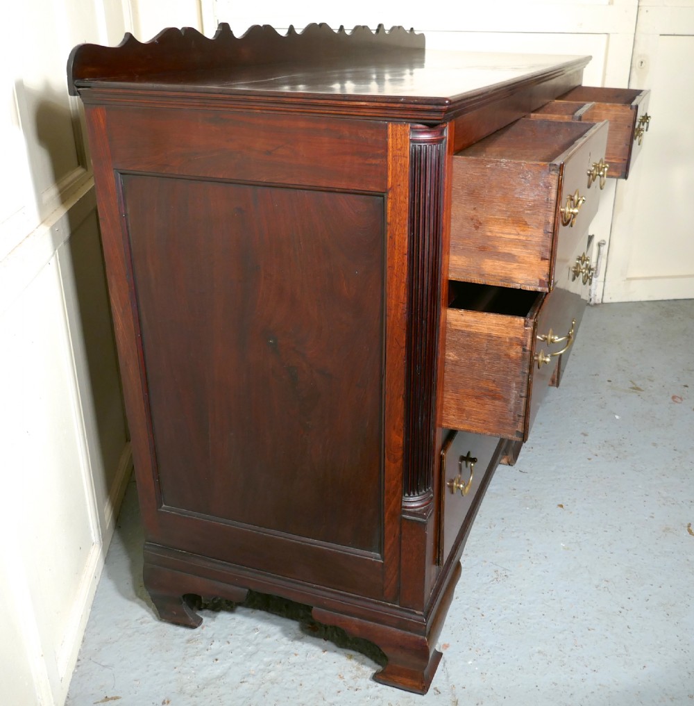A large George III mahogany Lancashire chest of drawers with seven drawers, brass swan-neck handles, a shaped gallery upstand, and bracket feet. View II