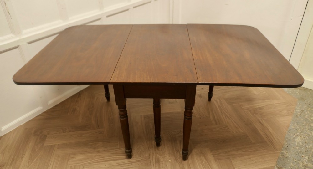 A Victorian mahogany drop-leaf table with turned legs and two hinged rectangular side flaps. View III