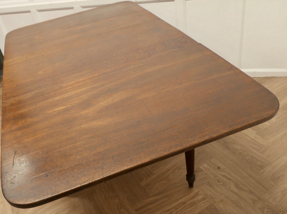 A Victorian mahogany drop-leaf table with turned legs and two hinged rectangular side flaps. View IV