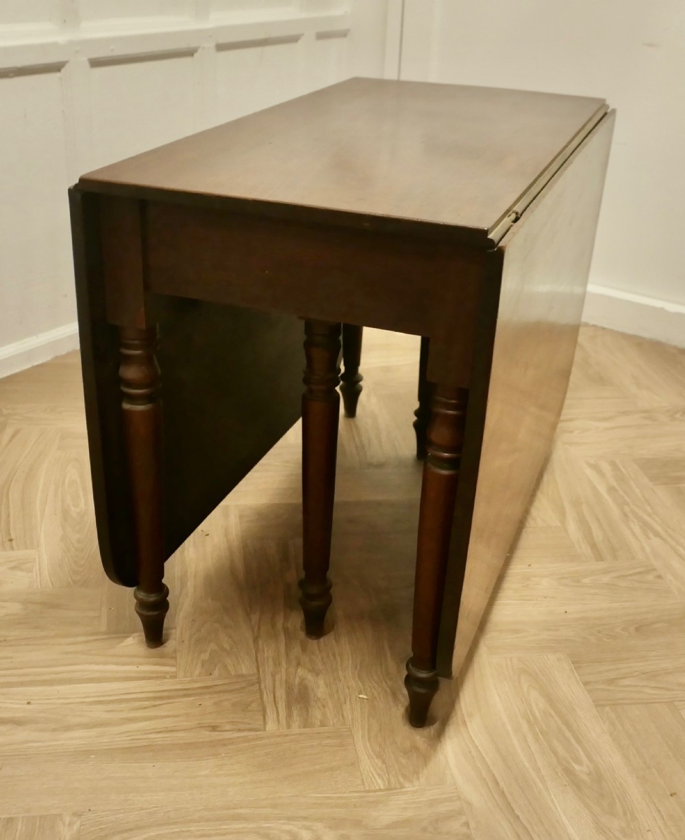A Victorian mahogany drop-leaf table with turned legs and two hinged rectangular side flaps. View XI