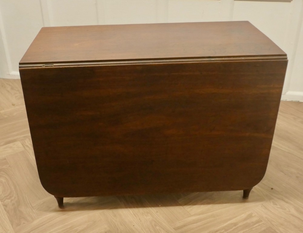 A Victorian mahogany drop-leaf table with turned legs and two hinged rectangular side flaps. View XII