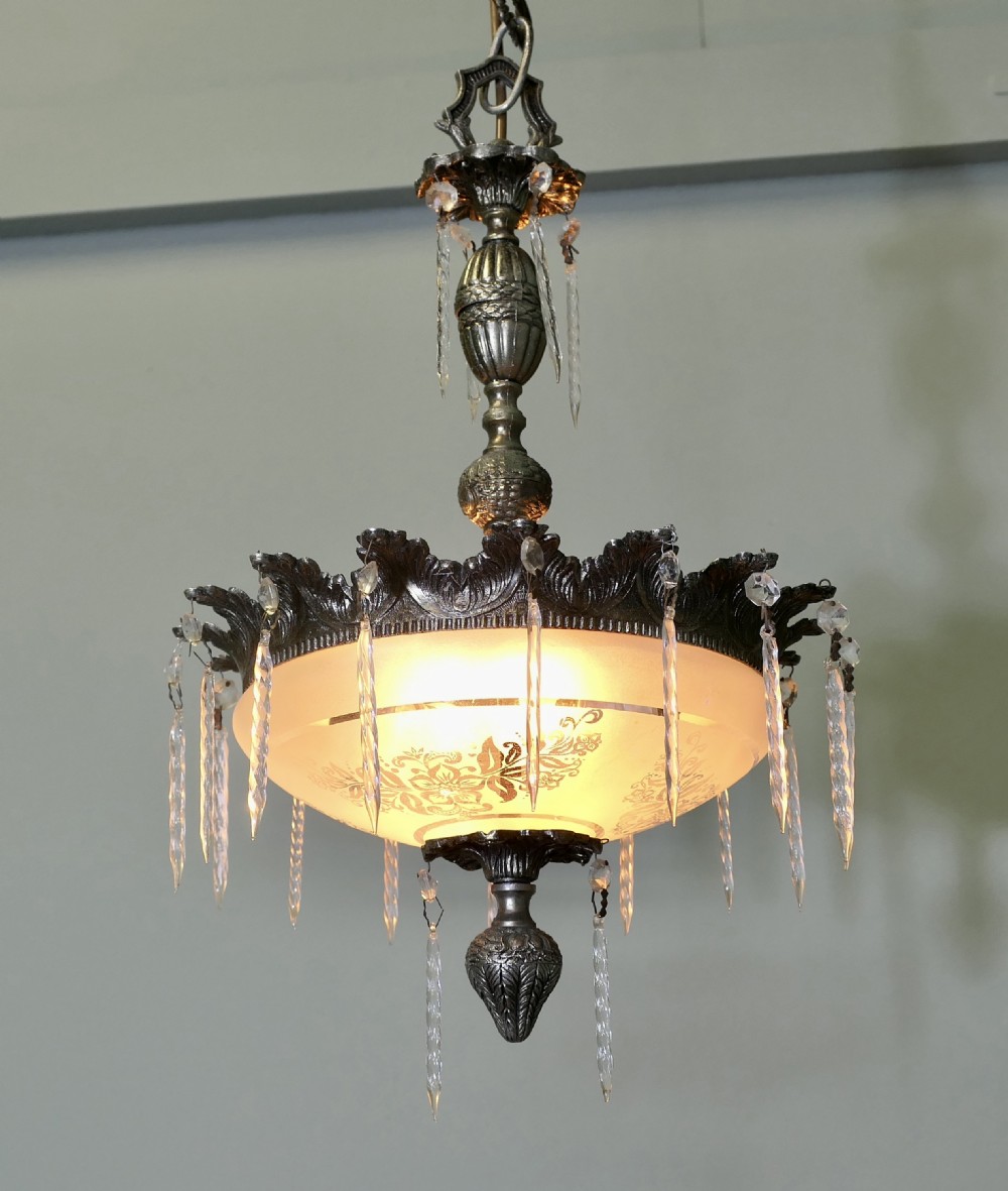 An antique French ceiling pendant light crafted from cast brass featuring a central frosted glass bowl embellished with clear hanging crystal drops and suspended by a decorative chain. View III