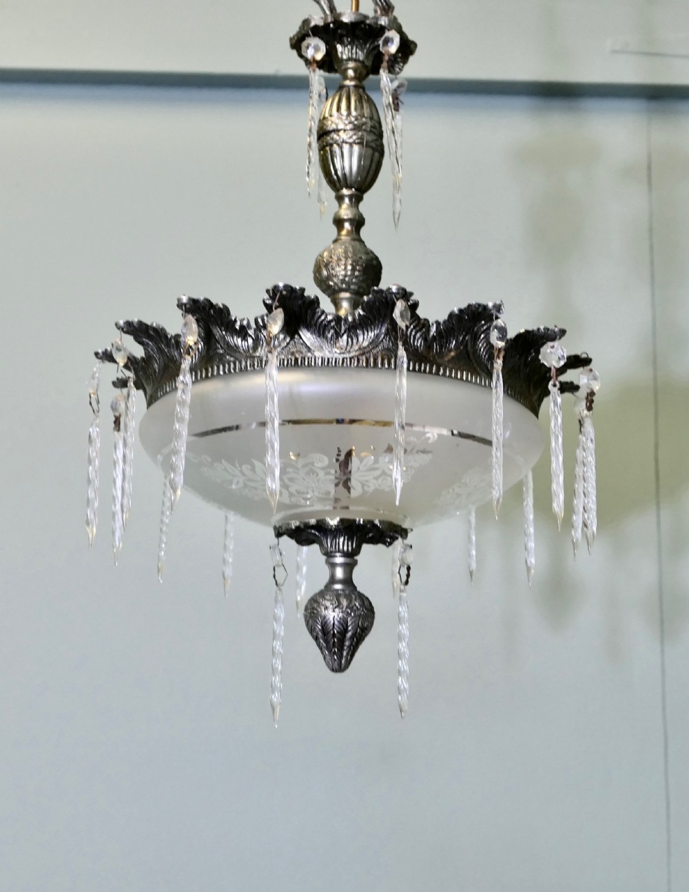 An antique French ceiling pendant light crafted from cast brass featuring a central frosted glass bowl embellished with clear hanging crystal drops and suspended by a decorative chain. View VI