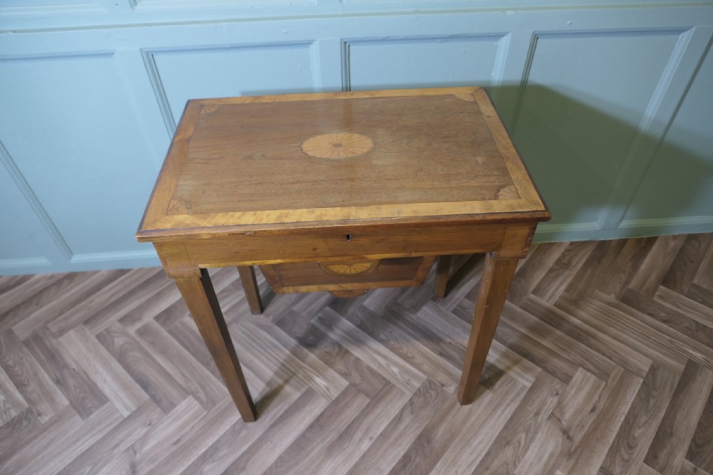 An Edwardian satin walnut sewing work table with tapered square legs, a fitted central drawer, and decorative fan marquetry inlay. View II