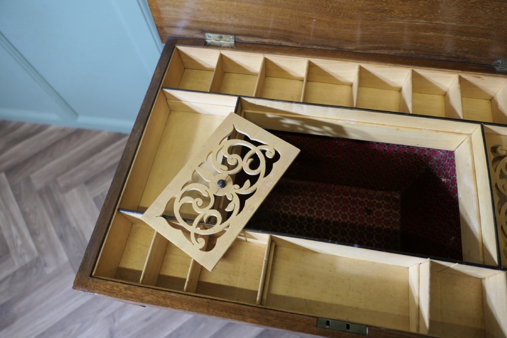 An Edwardian satin walnut sewing work table with tapered square legs, a fitted central drawer, and decorative fan marquetry inlay. View V
