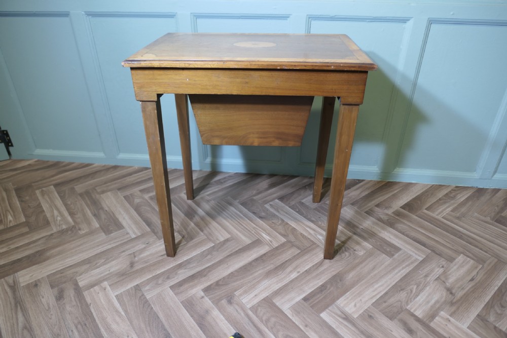 An Edwardian satin walnut sewing work table with tapered square legs, a fitted central drawer, and decorative fan marquetry inlay. View XI
