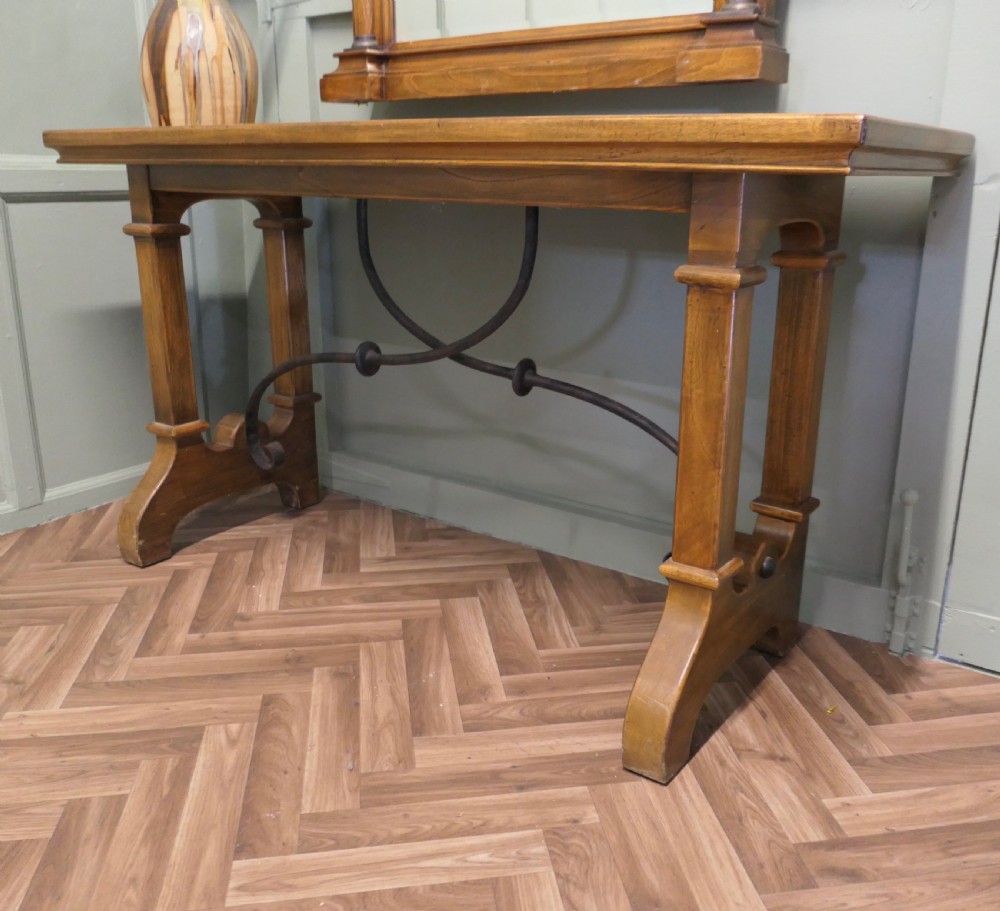 A golden oak console table featuring curved wrought iron stretchers paired with a matching framed wall mirror. View VI