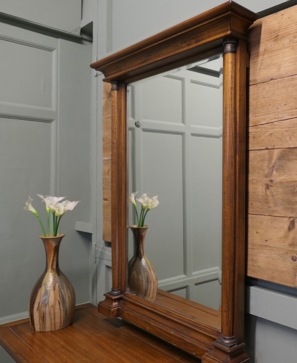 A golden oak console table featuring curved wrought iron stretchers paired with a matching framed wall mirror. View VIII