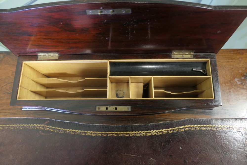 An Edwardian satin walnut ladies writing desk featuring a top superstructure with brass gallery, single drawer with marquetry oval inlay, tapered square legs, and an undertier shelf on brass castors. View V