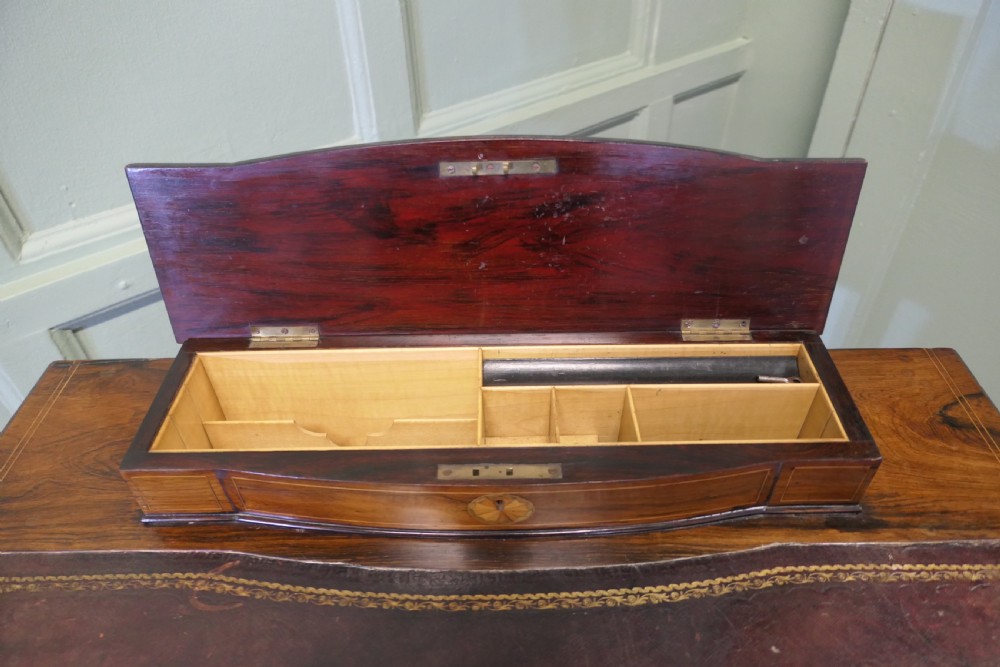 An Edwardian satin walnut ladies writing desk featuring a top superstructure with brass gallery, single drawer with marquetry oval inlay, tapered square legs, and an undertier shelf on brass castors. View IX