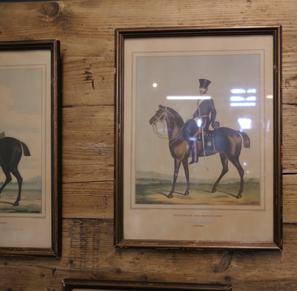A set of five framed antique prints depicting British Army cavalry officers in uniform mounted on horses. View III
