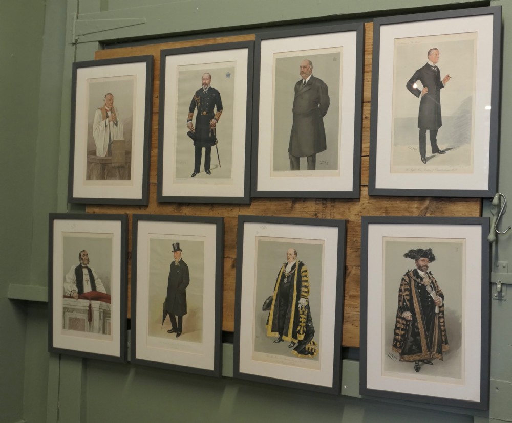 A collection of eight framed Vanity Fair caricature prints depicting Victorian and Edwardian figures displayed in matching dark frames. View II