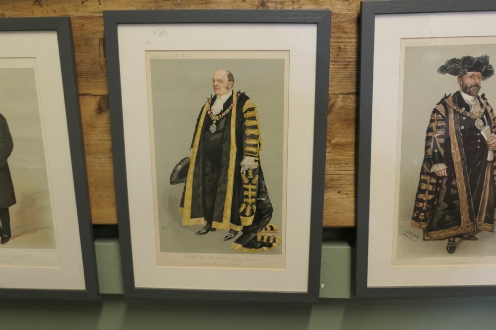 A collection of eight framed Vanity Fair caricature prints depicting Victorian and Edwardian figures displayed in matching dark frames. View IV