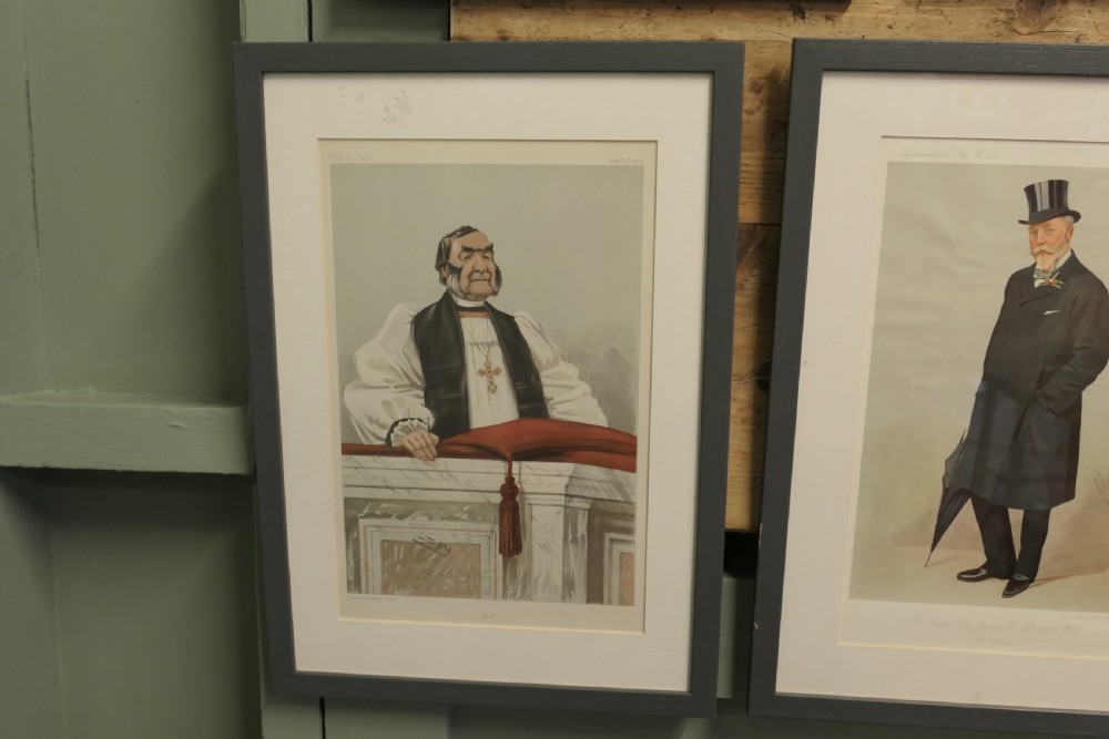 A collection of eight framed Vanity Fair caricature prints depicting Victorian and Edwardian figures displayed in matching dark frames. View V