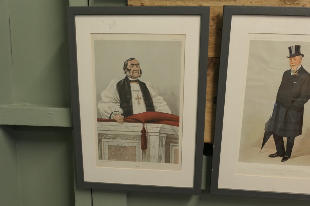 A collection of eight framed Vanity Fair caricature prints depicting Victorian and Edwardian figures displayed in matching dark frames. View VI