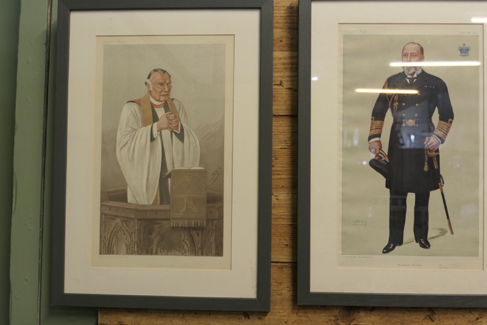 A collection of eight framed Vanity Fair caricature prints depicting Victorian and Edwardian figures displayed in matching dark frames. View VII