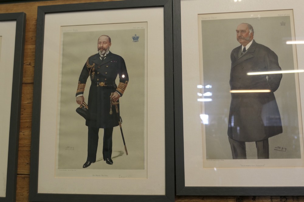 A collection of eight framed Vanity Fair caricature prints depicting Victorian and Edwardian figures displayed in matching dark frames. View VIII