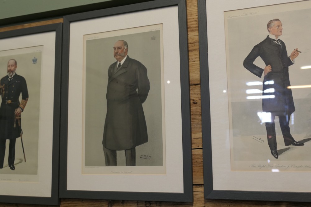 A collection of eight framed Vanity Fair caricature prints depicting Victorian and Edwardian figures displayed in matching dark frames. View X