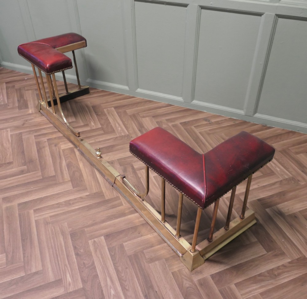 An Extending Brass and Leather Club Fender View VII