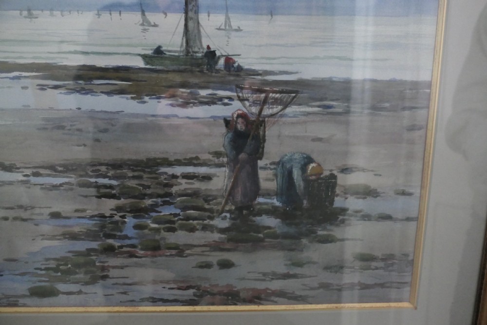 A framed coastal watercolour painting featuring figures on a shore with fishing boats in the distance beneath a cloudy blue sky. View II