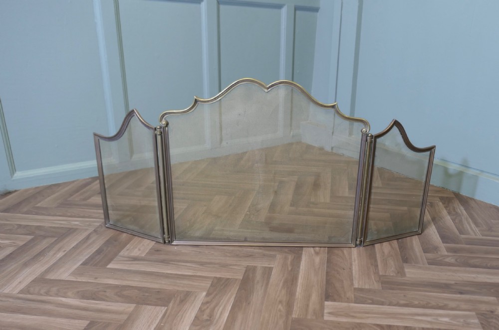 A three-panel folding French brass fire guard with fine wire mesh and a serpentine crest rail. View II