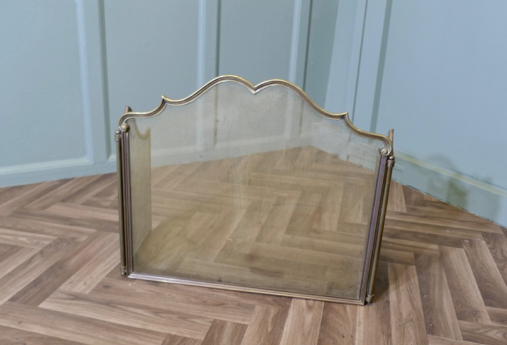 A three-panel folding French brass fire guard with fine wire mesh and a serpentine crest rail. View III