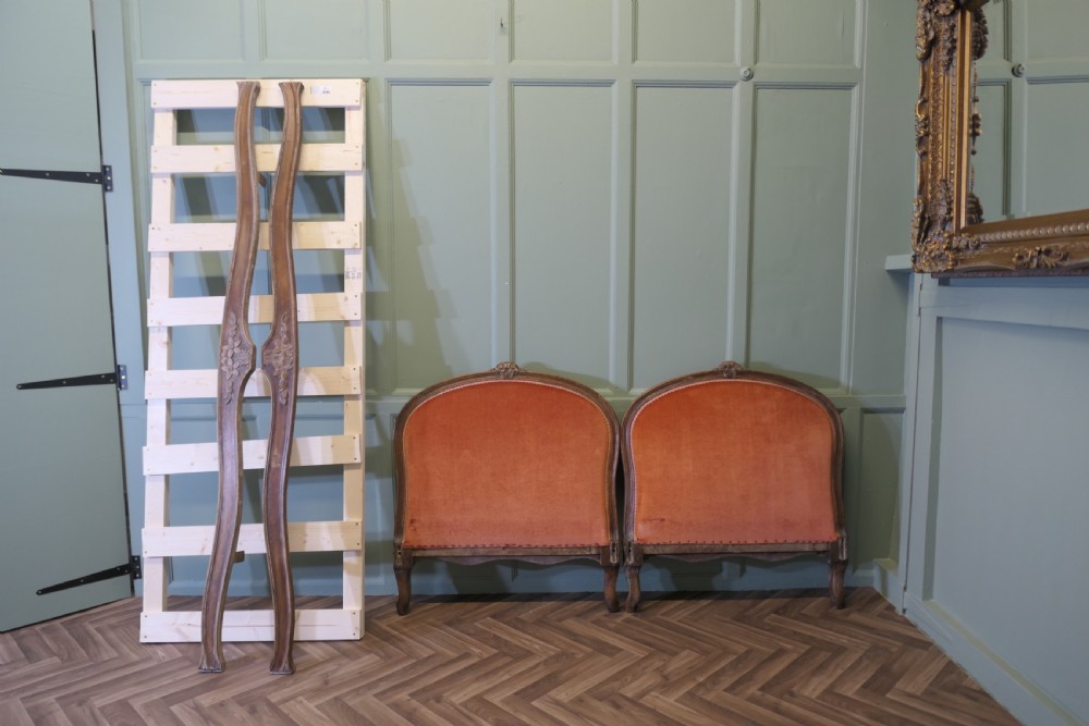 A 19th-century French carved wood daybed featuring raised terracotta velvet upholstered end panels and a tufted cream mattress cushion. View III