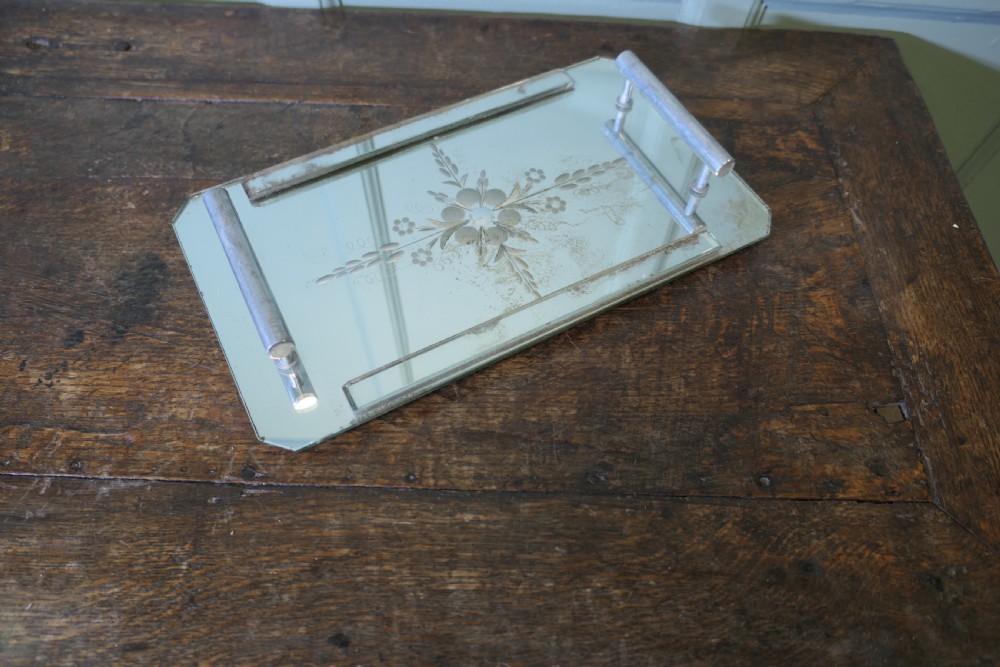 A rectangular Art Deco mirrored tray featuring central etched floral details, cut corners, and tubular silver-tone handles. View II