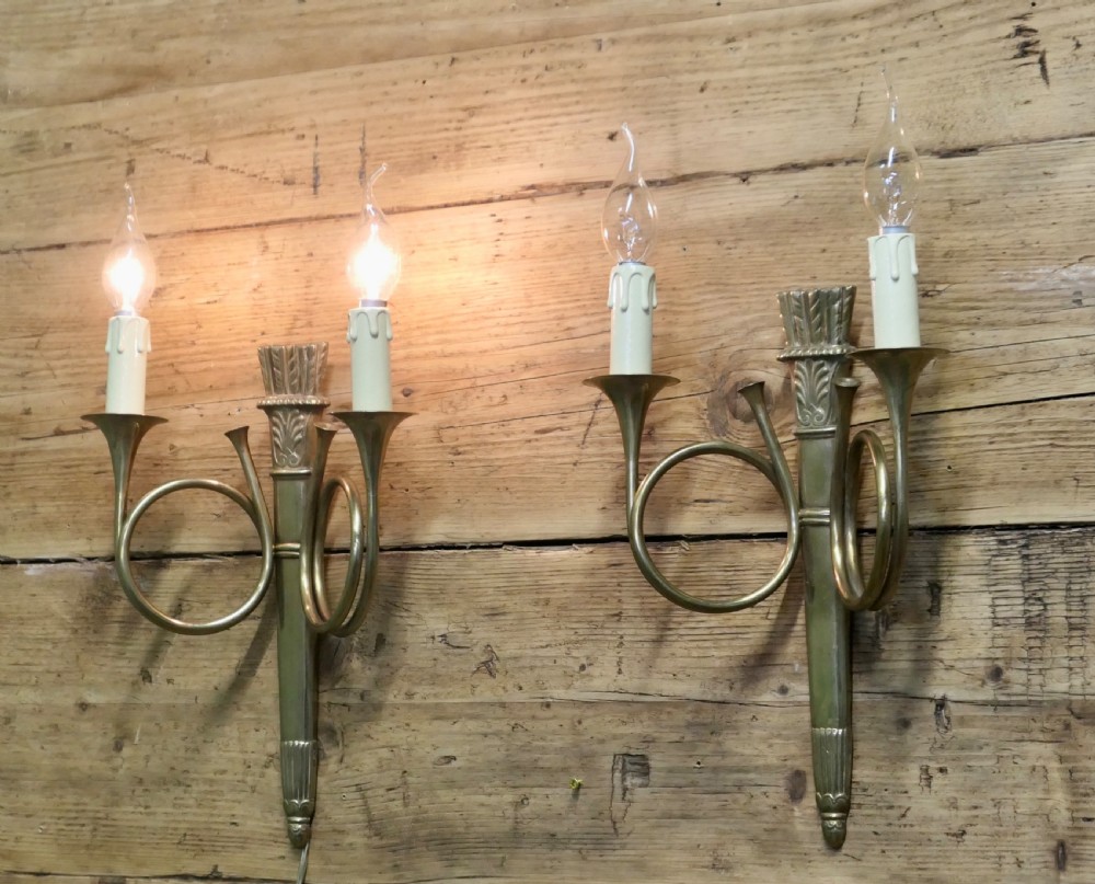 A pair of French Art Deco brass wall sconces formed in the shape of double hunting horns with candle bulb holders. View II