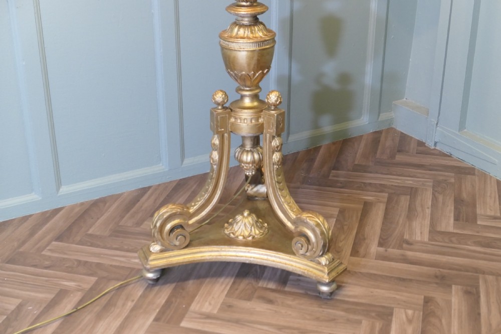 A tall antique carved giltwood floor lamp featuring a fluted column, scrolled tripod base, and a pleated cream fabric shade with embroidered trimming. View III