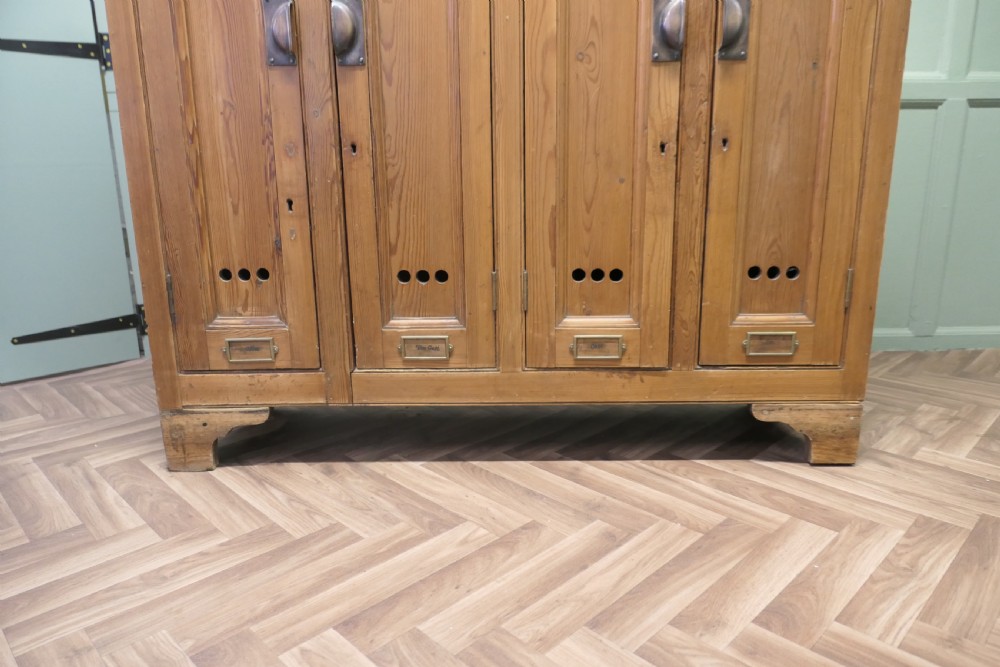 A four-door golden pine sports locker featuring numbered metal tags, circular ventilation holes, and brass fittings. View II