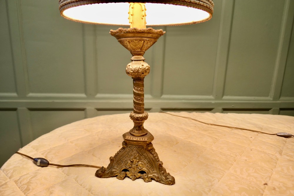 A pair of heavy French Gothic style brass table lamps featuring turned columns, ornate openwork bases, and green fabric shades. View III