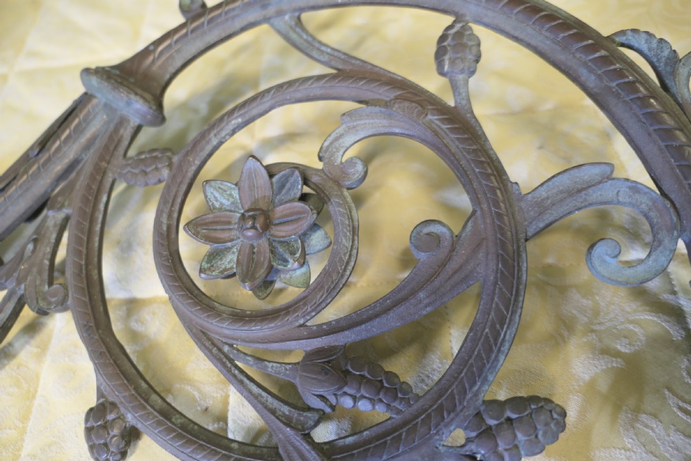 A pair of elaborate dark patinated French bronze wall brackets featuring scrollwork, floral rosettes, and pinecone motifs. View IV