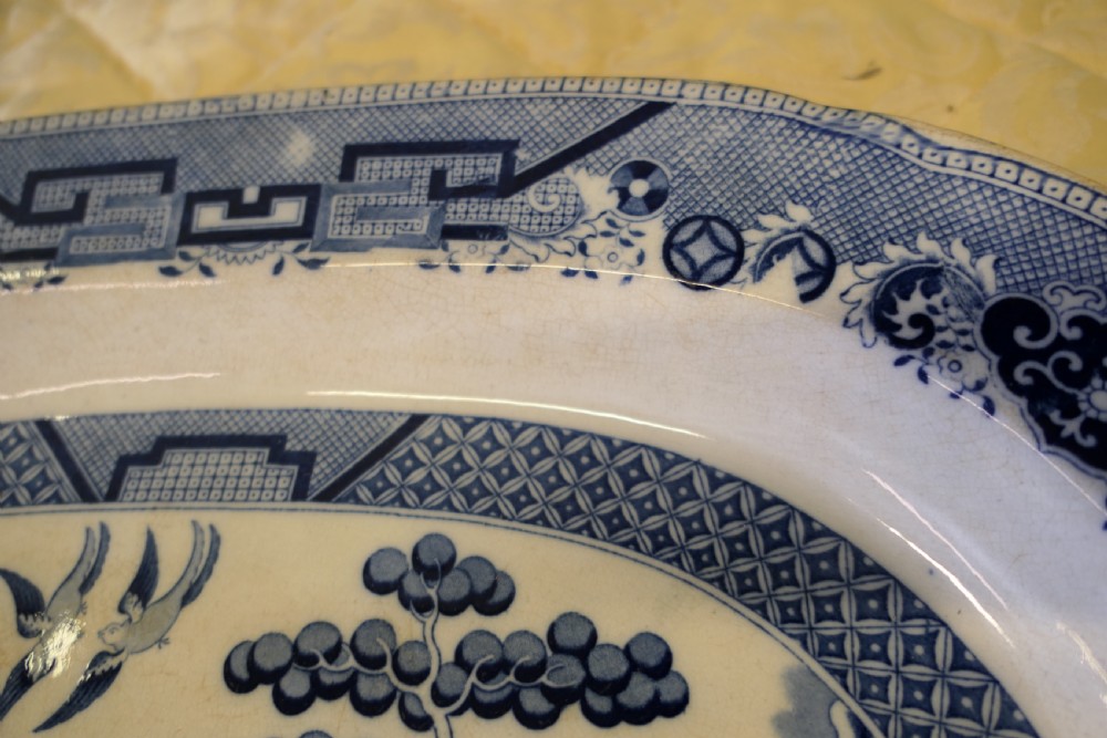 An oval Victorian ironstone meat platter featuring a cobalt blue Willow transferware pattern on a white glazed ceramic ground. View II