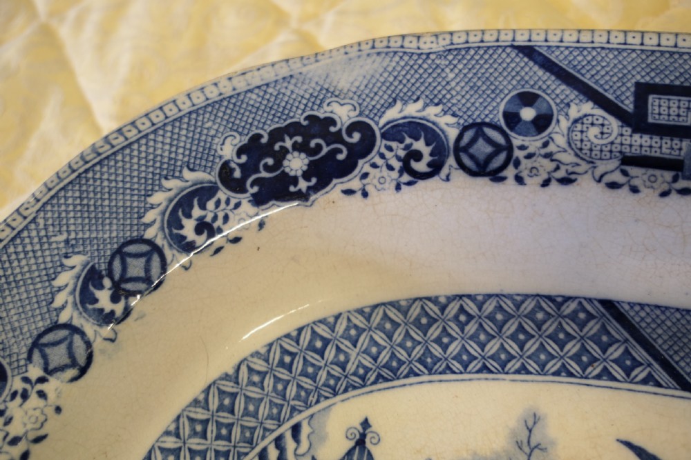 An oval Victorian ironstone meat platter featuring a cobalt blue Willow transferware pattern on a white glazed ceramic ground. View III