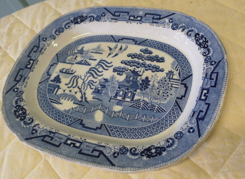 An oval Victorian ironstone meat platter featuring a cobalt blue Willow transferware pattern on a white glazed ceramic ground. View V