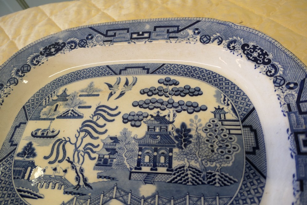 An oval Victorian ironstone meat platter featuring a cobalt blue Willow transferware pattern on a white glazed ceramic ground. View VI