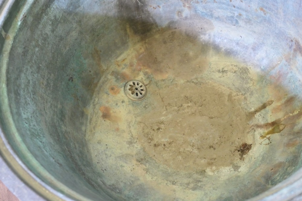 An early 19th-century large copper cauldron with a broad rolled rim and aged patinated surface finish. View IV