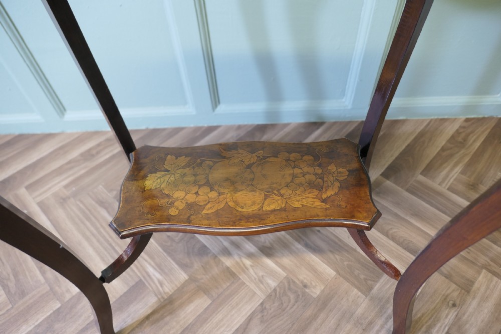 A warm brown wooden occasional table featuring a shaped serpentine top with central floral decoration, slender cabriole legs, and a decorated lower shelf. View III