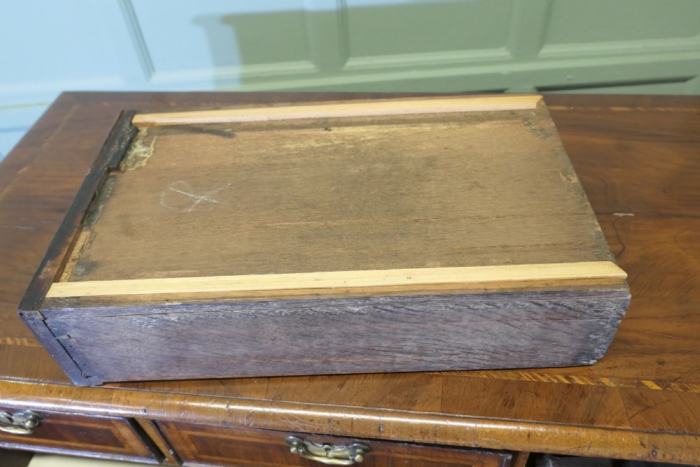 An 18th-century chest of drawers featuring inlaid walnut and satinwood crossbanding with brass drop handles and bracket feet. View VIII