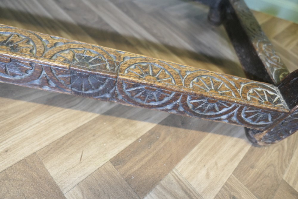 A dark oak rectangular occasional table with hand-carved Celtic knotwork detailing, a relief carved apron, turned legs, and lower stretchers. View II
