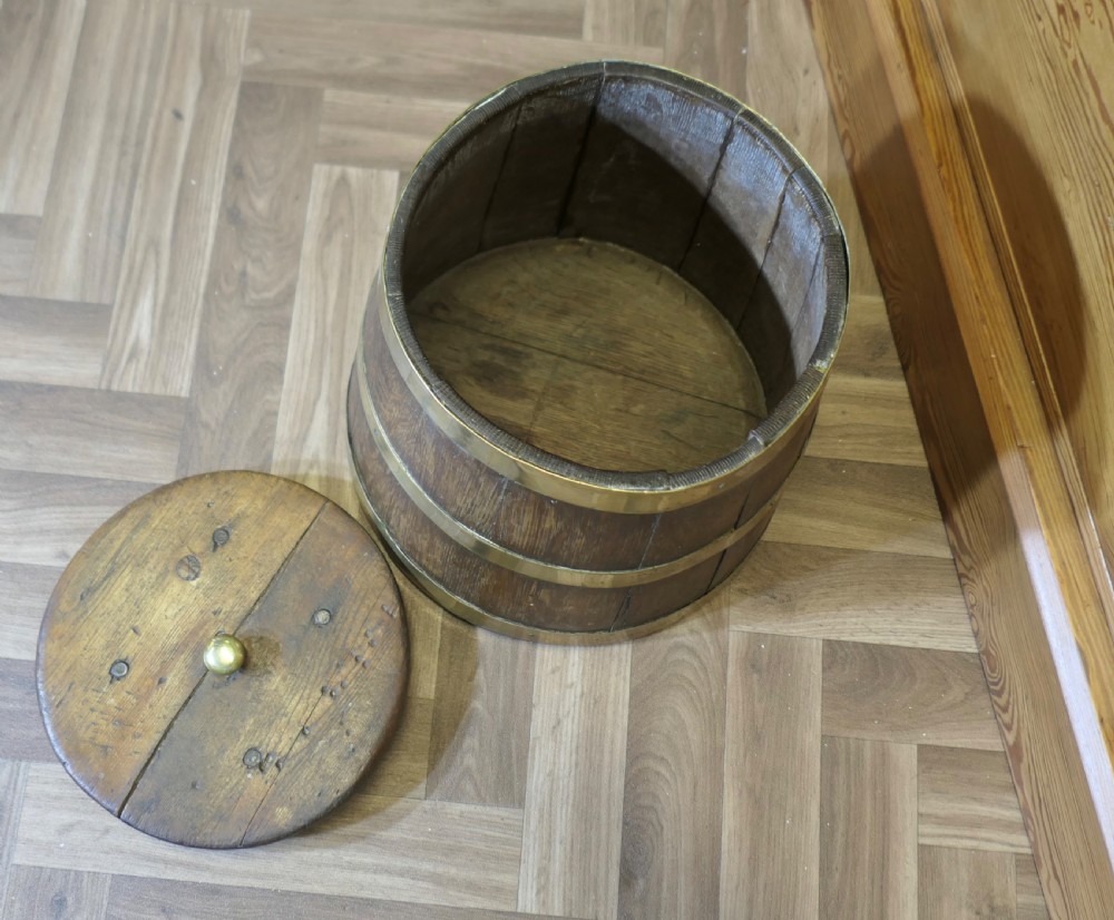 A cylindrical staved oak grog tub bound with three brass bands and fitted with a flat wooden lid with a central brass finial. View III