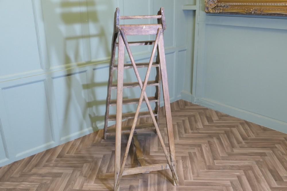 A nineteenth-century folding pine step ladder featuring scalloped wooden side supports and aged timber treads. View VII