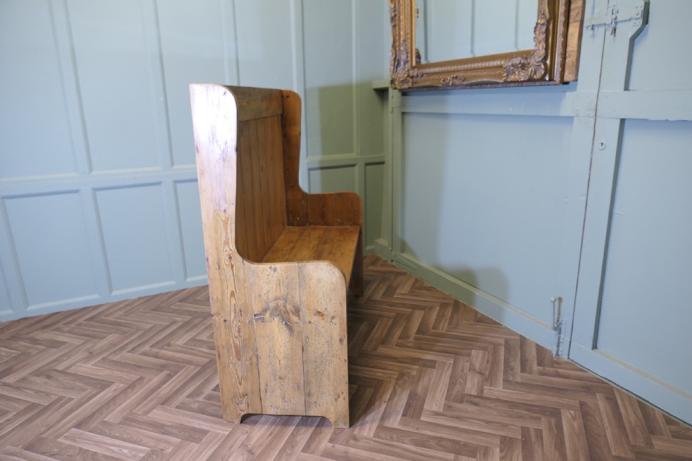 A high-back rustic pine settle bench featuring vertical planking and solid side panels in a natural honey wood finish. View VII
